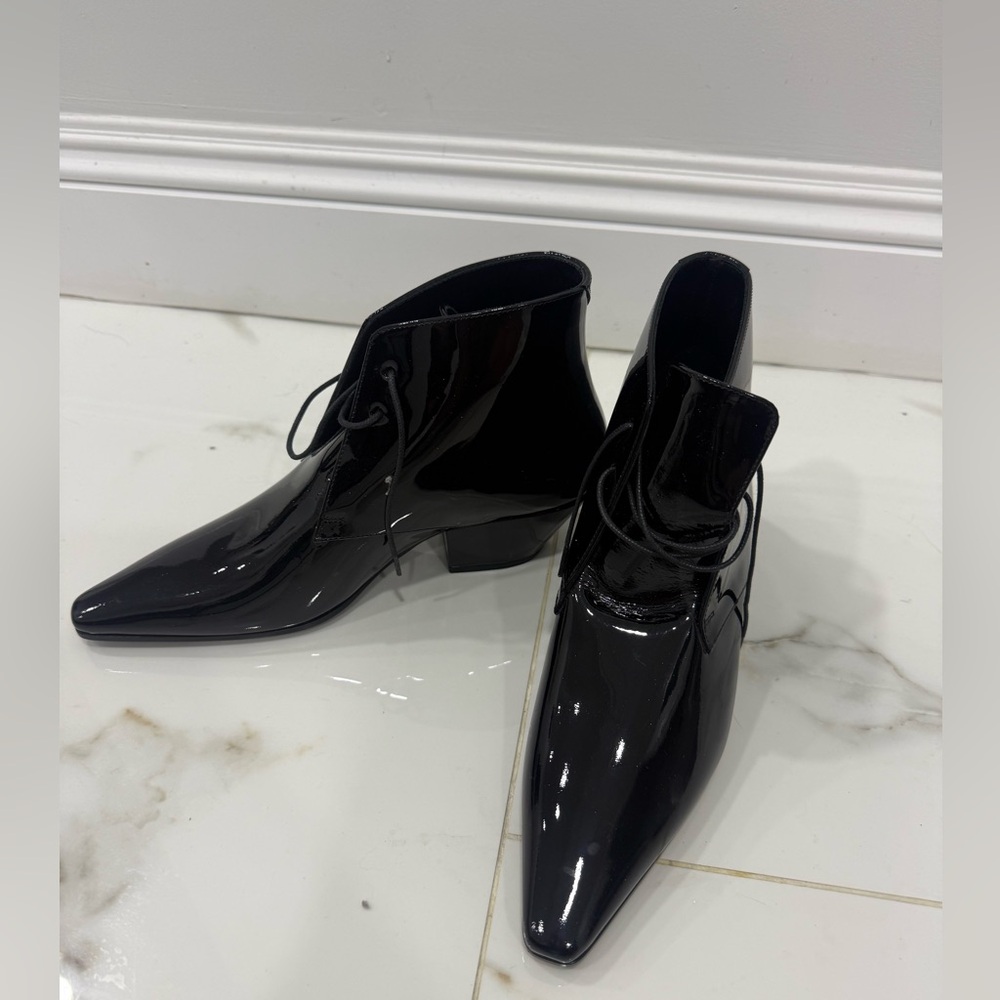 SAINT LAURENT patent leather lace up boots.